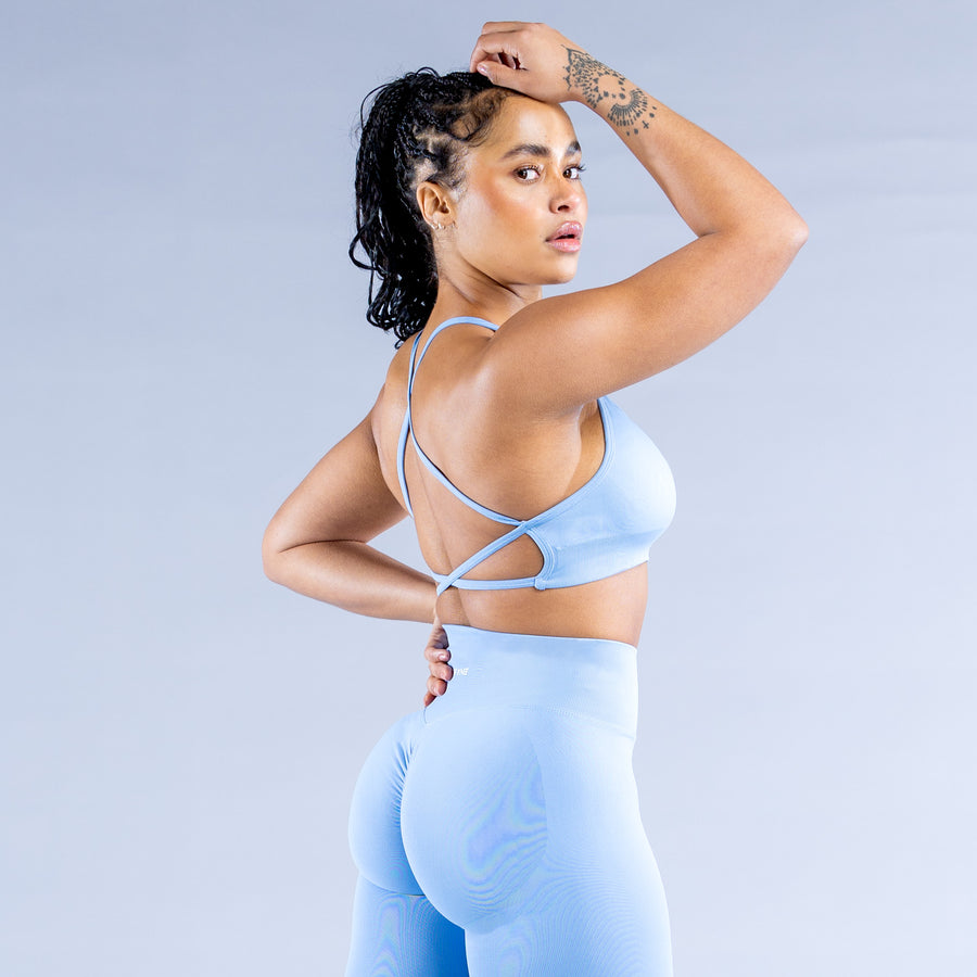 Light blue sports bra with crisscross back straps and supportive wide band